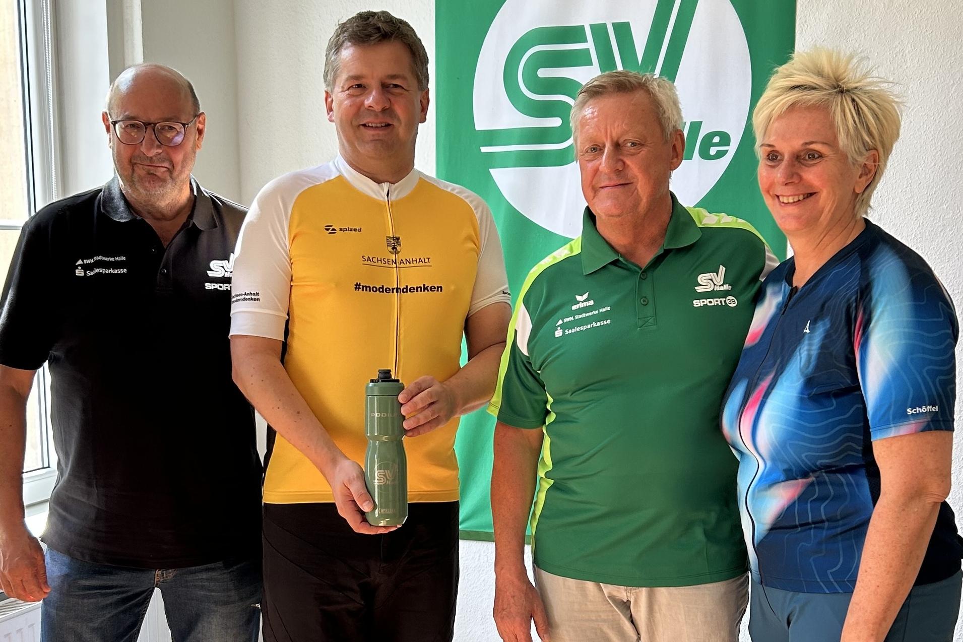 MP Sven Schulze besucht den SV Halle Ministerpräsident Sven Schulze besucht im Rahmen seiner Wahlkampftour den SV Halle. Zusammen mit Ingo Michalak, Hardy Gnewuch und Silke Renk hält er eine Trinkflasche des SV Halle hoch.